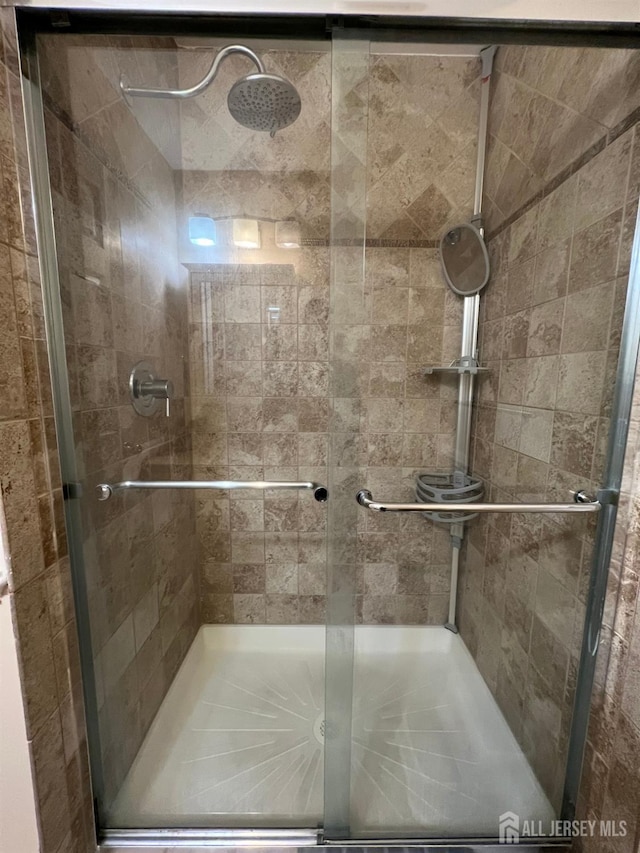 bathroom with a shower with door