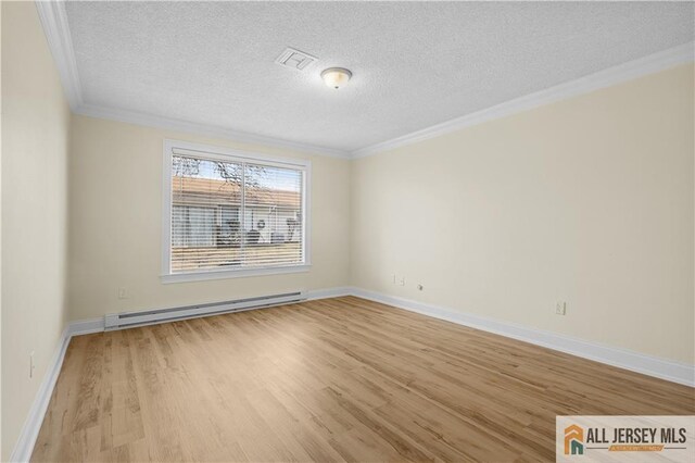 empty room featuring crown molding, a textured ceiling, baseboard heating, and light hardwood / wood-style floors