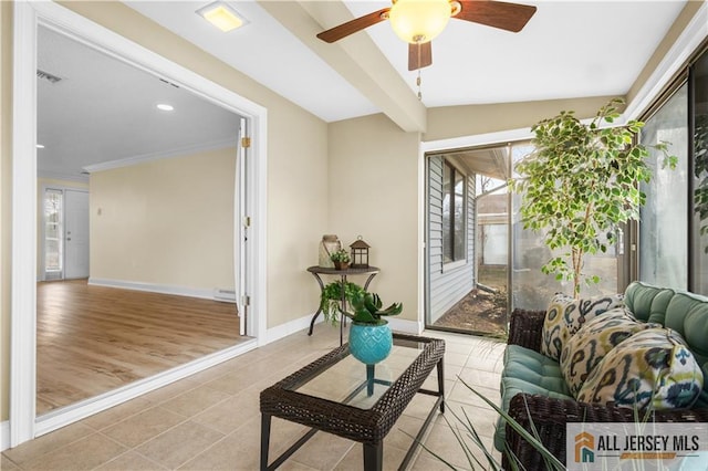 tiled living room with crown molding and ceiling fan