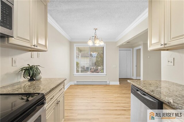 kitchen with cream cabinets, a baseboard heating unit, stainless steel appliances, crown molding, and light stone countertops