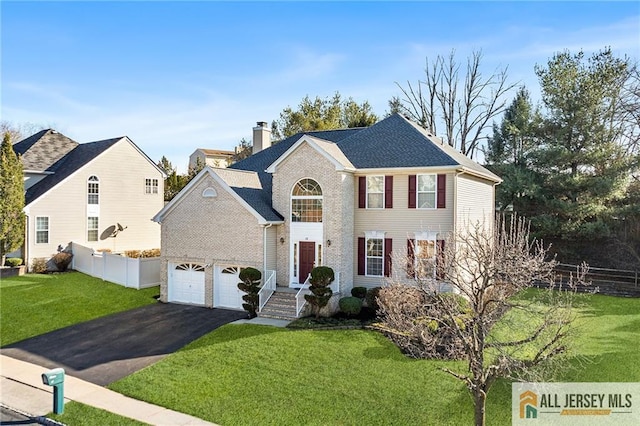 view of front facade featuring a front lawn, driveway, fence, a garage, and a chimney