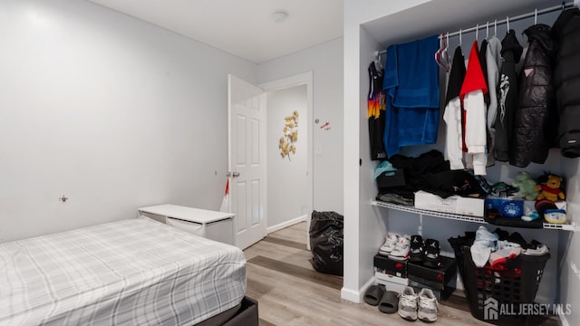 bedroom featuring wood finished floors and baseboards