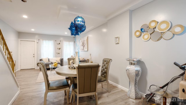 dining room featuring light wood-type flooring, stairway, baseboards, and recessed lighting