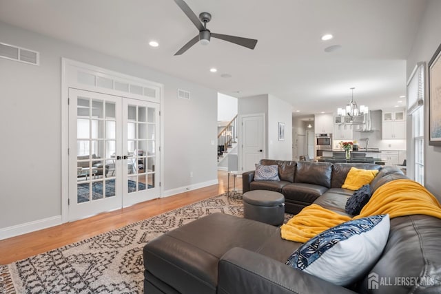 living area featuring recessed lighting, stairway, visible vents, and light wood-style flooring