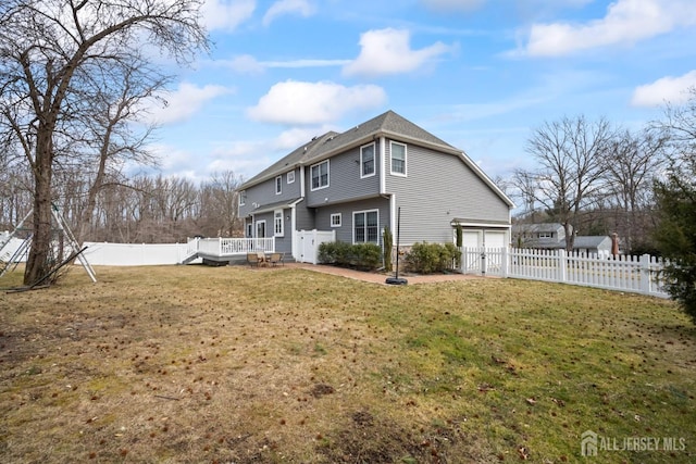 exterior space with a deck, a yard, and a fenced backyard