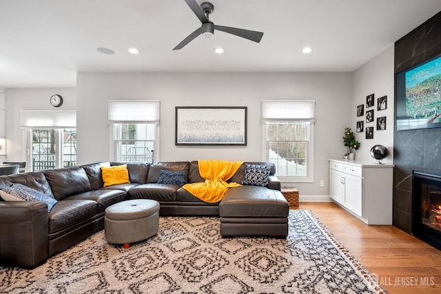 living area featuring recessed lighting, a fireplace, and light wood-type flooring