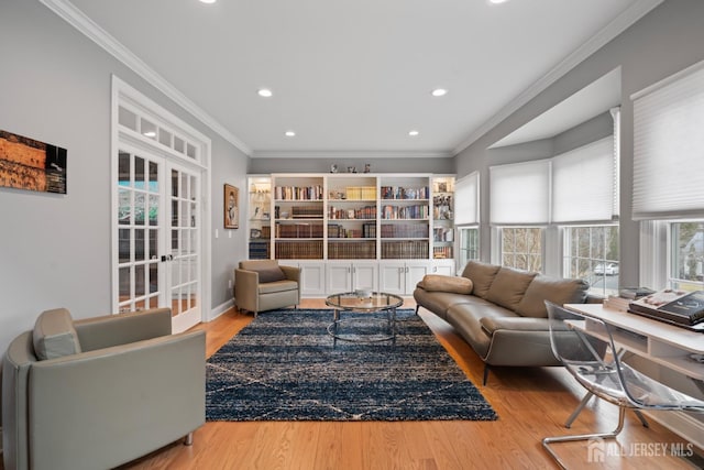 living room with wood finished floors, recessed lighting, french doors, crown molding, and baseboards