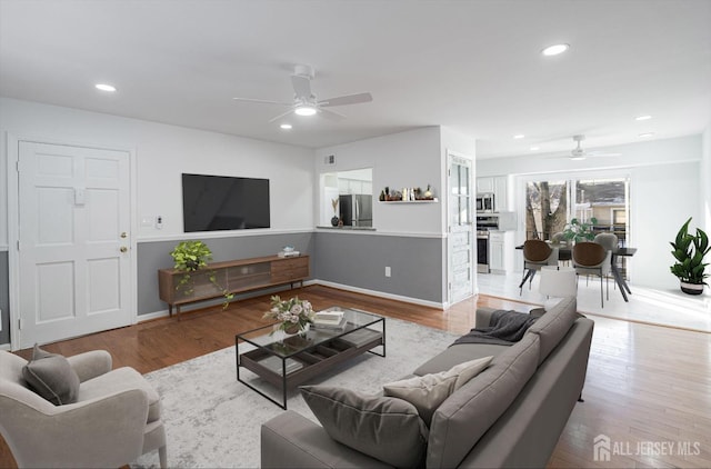 living room featuring recessed lighting, wood finished floors, baseboards, and ceiling fan