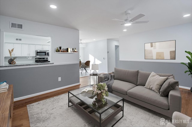 living area with recessed lighting, visible vents, ceiling fan, and light wood finished floors