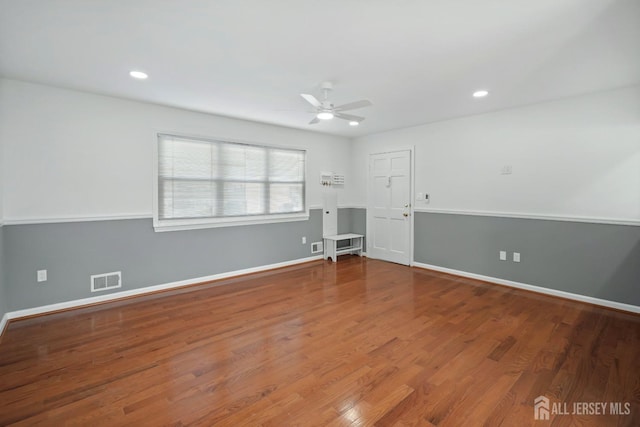 spare room with wood-type flooring and ceiling fan