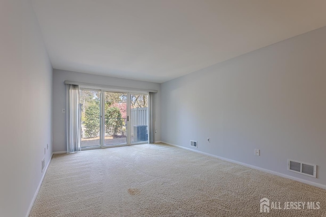 1027 Schmidt Ln, North Brunswick, NJ 08902 - carpeted spare room featuring baseboards