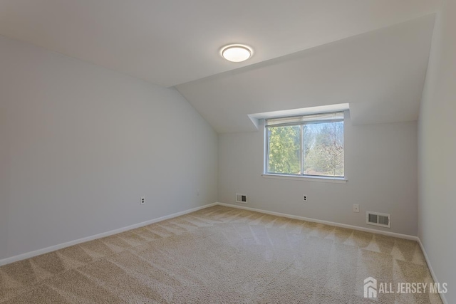 1027 Schmidt Ln, North Brunswick, NJ 08902 - additional living space with vaulted ceiling and light carpet