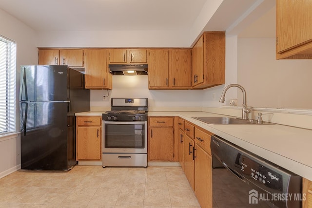 1027 Schmidt Ln, North Brunswick, NJ 08902 - kitchen featuring black appliances, light countertops, under cabinet range hood, light tile patterned flooring, and brown cabinetry