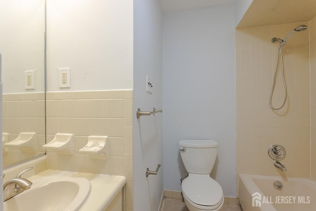 1027 Schmidt Ln, North Brunswick, NJ 08902 - bathroom featuring shower / bathtub combination, vanity, and tile walls