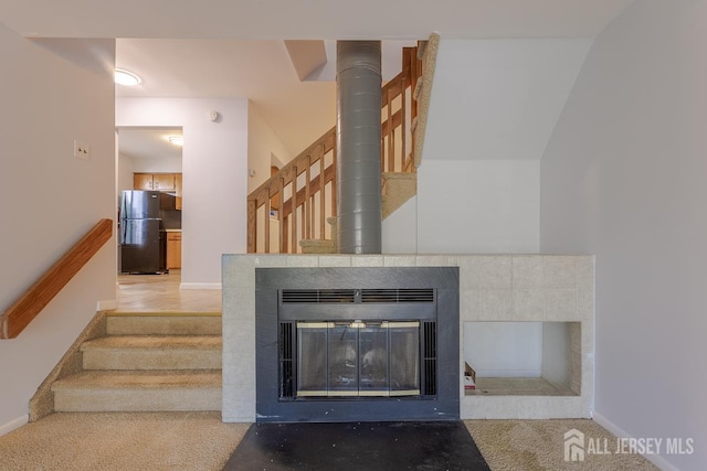 1027 Schmidt Ln, North Brunswick, NJ 08902 - staircase featuring carpet and a glass covered fireplace