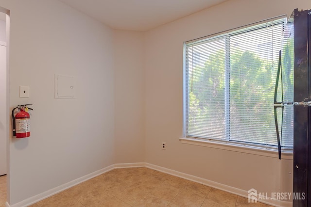 1027 Schmidt Ln, North Brunswick, NJ 08902 - spare room featuring plenty of natural light and light tile patterned floors