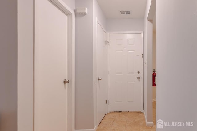 1027 Schmidt Ln, North Brunswick, NJ 08902 - corridor with light tile patterned floors and baseboards