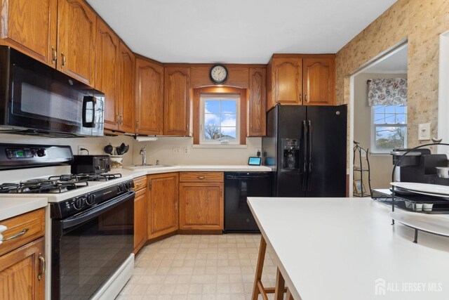 341 Ellis Pkwy, Piscataway, NJ 08854 - kitchen with black appliances, brown cabinets, and light countertops