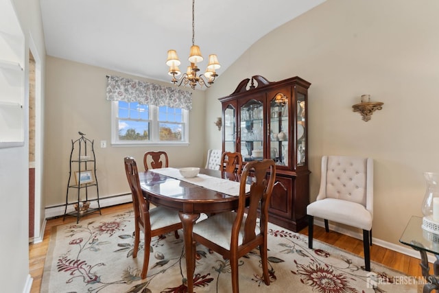 341 Ellis Pkwy, Piscataway, NJ 08854 - dining space featuring a baseboard radiator, a chandelier, vaulted ceiling, light wood finished floors, and baseboards