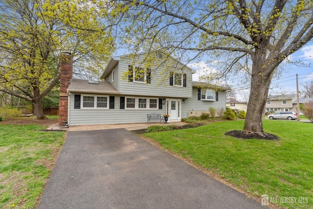 341 Ellis Pkwy, Piscataway, NJ 08854 - tri-level home featuring asphalt driveway, a front yard, a chimney, and roof with shingles
