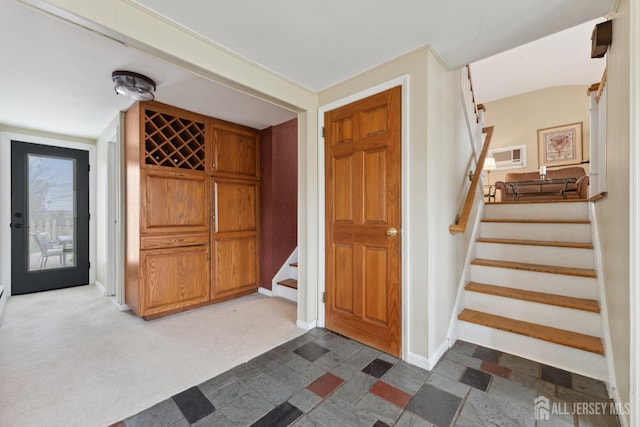 341 Ellis Pkwy, Piscataway, NJ 08854 - foyer entrance with stairs, baseboards, and dark colored carpet