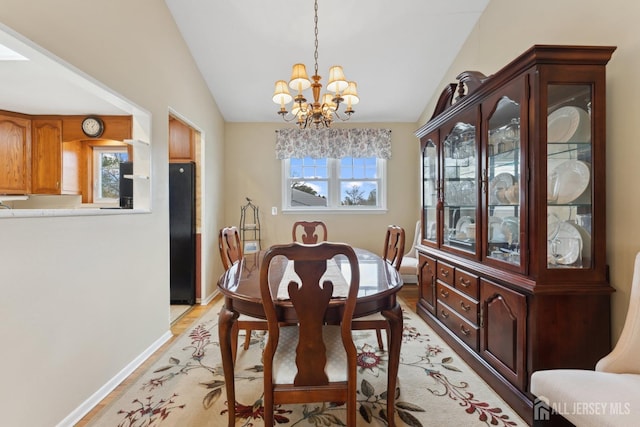 341 Ellis Pkwy, Piscataway, NJ 08854 - dining space featuring lofted ceiling, a chandelier, light wood-type flooring, and baseboards