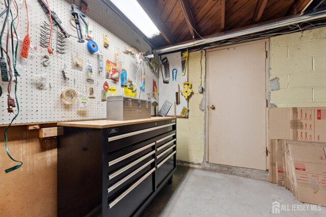 341 Ellis Pkwy, Piscataway, NJ 08854 - unfinished below grade area with a workshop area and concrete block wall