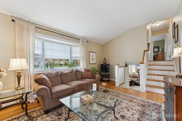 341 Ellis Pkwy, Piscataway, NJ 08854 - living room featuring wood finished floors, lofted ceiling, and stairs
