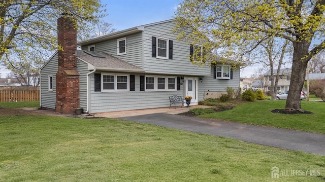 341 Ellis Pkwy, Piscataway, NJ 08854 - tri-level home with a chimney, a shingled roof, and driveway