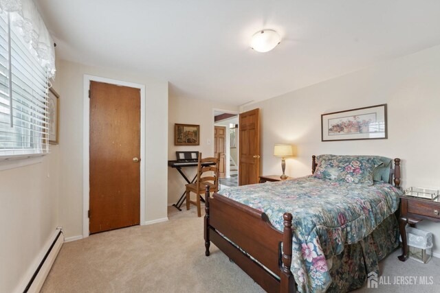 341 Ellis Pkwy, Piscataway, NJ 08854 - bedroom featuring baseboard heating, light colored carpet, and baseboards