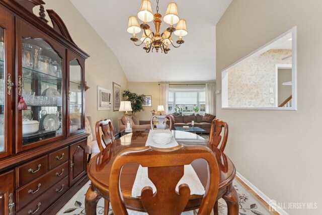 341 Ellis Pkwy, Piscataway, NJ 08854 - dining area with a chandelier, lofted ceiling, and baseboards