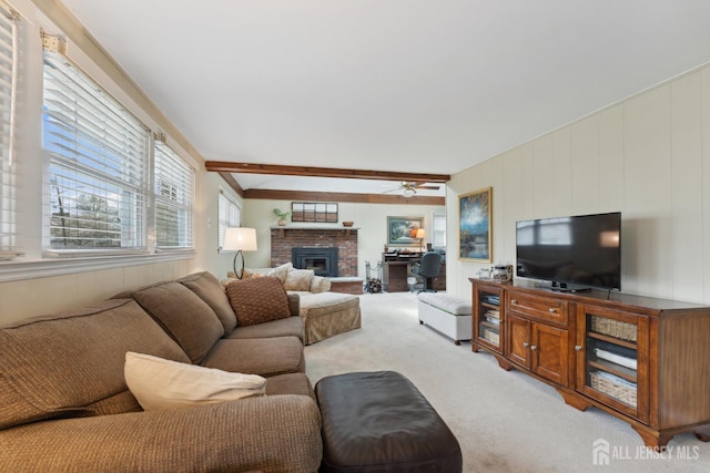 341 Ellis Pkwy, Piscataway, NJ 08854 - living area with light carpet, a ceiling fan, a fireplace, and beamed ceiling