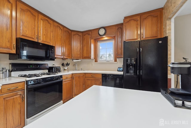 341 Ellis Pkwy, Piscataway, NJ 08854 - kitchen featuring black appliances, light countertops, and brown cabinets