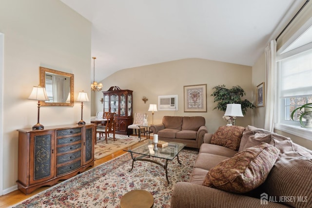 341 Ellis Pkwy, Piscataway, NJ 08854 - living area with wood finished floors, an AC wall unit, lofted ceiling, and baseboards