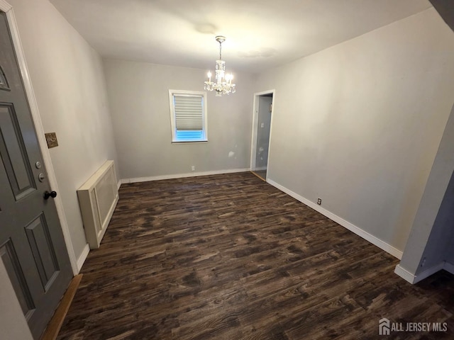 4 Vale St, Edison, NJ 08817 - empty room with a chandelier and dark wood-style flooring