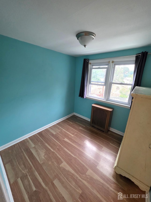 4 Vale St, Edison, NJ 08817 - unfurnished bedroom featuring radiator and wood finished floors
