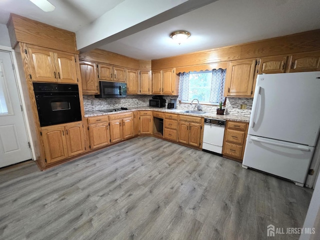 4 Vale St, Edison, NJ 08817 - kitchen with black appliances, light wood finished floors, and decorative backsplash