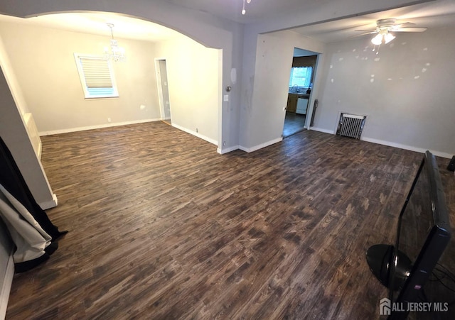 4 Vale St, Edison, NJ 08817 - unfurnished living room featuring ceiling fan, arched walkways, dark wood-style flooring, and a chandelier