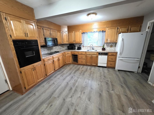 4 Vale St, Edison, NJ 08817 - kitchen featuring black appliances, light wood-style flooring, decorative backsplash, and brown cabinets
