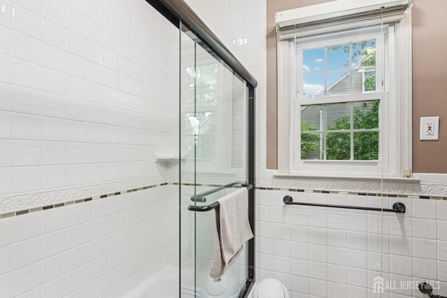 95 Union Ave, Edison, NJ 08820 - bathroom with tile walls, tiled shower, wainscoting, and toilet