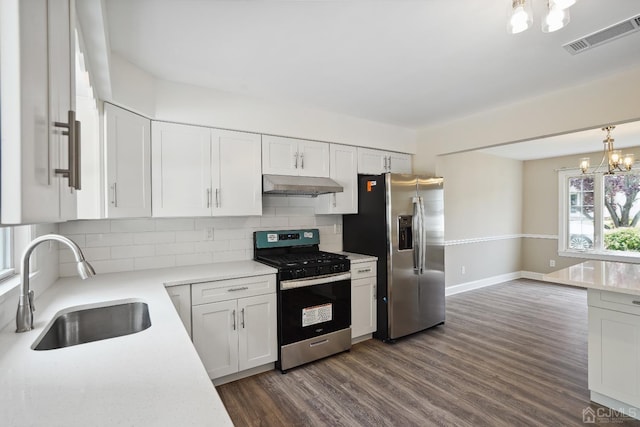 431-431 Garfield Ave, South Plainfield, NJ 07080 - kitchen featuring appliances with stainless steel finishes, a chandelier, under cabinet range hood, tasteful backsplash, and light countertops