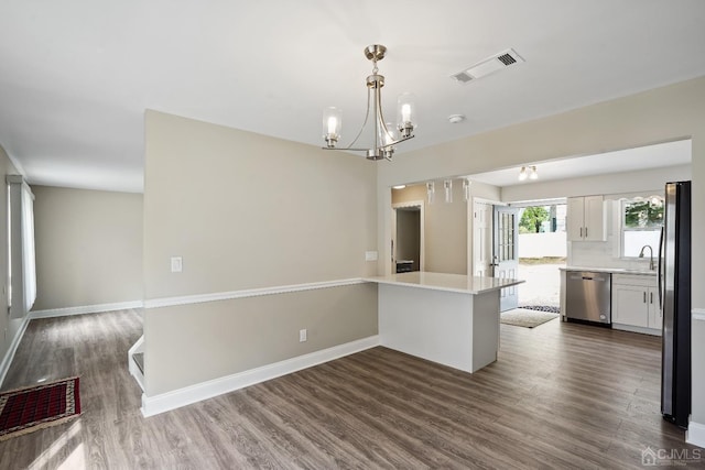 431-431 Garfield Ave, South Plainfield, NJ 07080 - kitchen featuring appliances with stainless steel finishes, a chandelier, dark wood-style floors, light countertops, and white cabinets