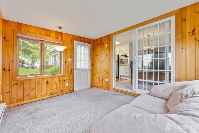 104 Glenwood Ln Unit A, Monroe, NJ 08831 - living room featuring healthy amount of natural light, wooden walls, carpet, a baseboard heating unit, and baseboards