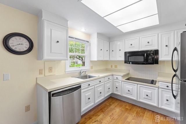 104 Glenwood Ln Unit A, Monroe, NJ 08831 - kitchen with black appliances, a sink, white cabinets, and light countertops