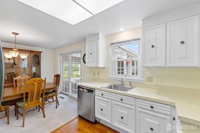104 Glenwood Ln Unit A, Monroe, NJ 08831 - kitchen featuring stainless steel dishwasher, a sink, a chandelier, white cabinetry, and light countertops