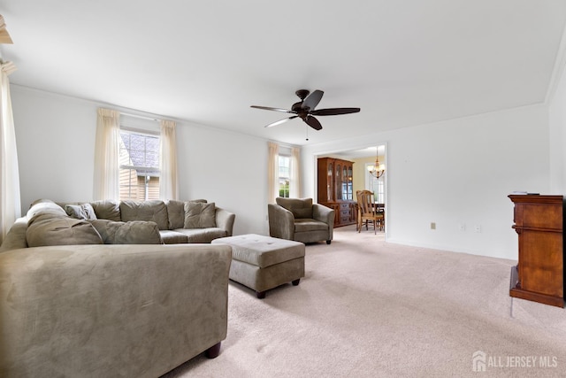104 Glenwood Ln Unit A, Monroe, NJ 08831 - living area featuring a ceiling fan, light carpet, a chandelier, baseboards, and crown molding