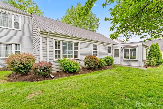 104 Glenwood Ln Unit A, Monroe, NJ 08831 - rear view of property featuring a yard and roof with shingles