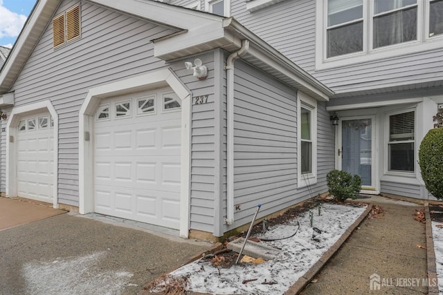 view of side of home featuring a garage