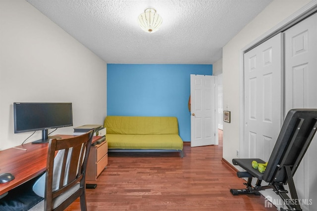 office with a textured ceiling and wood finished floors