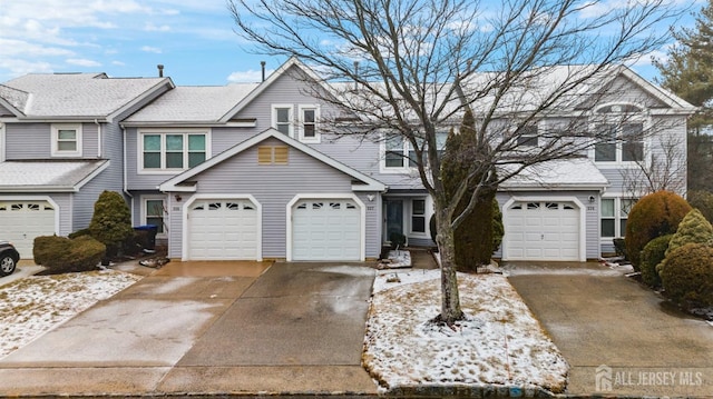 townhome / multi-family property featuring a garage and driveway